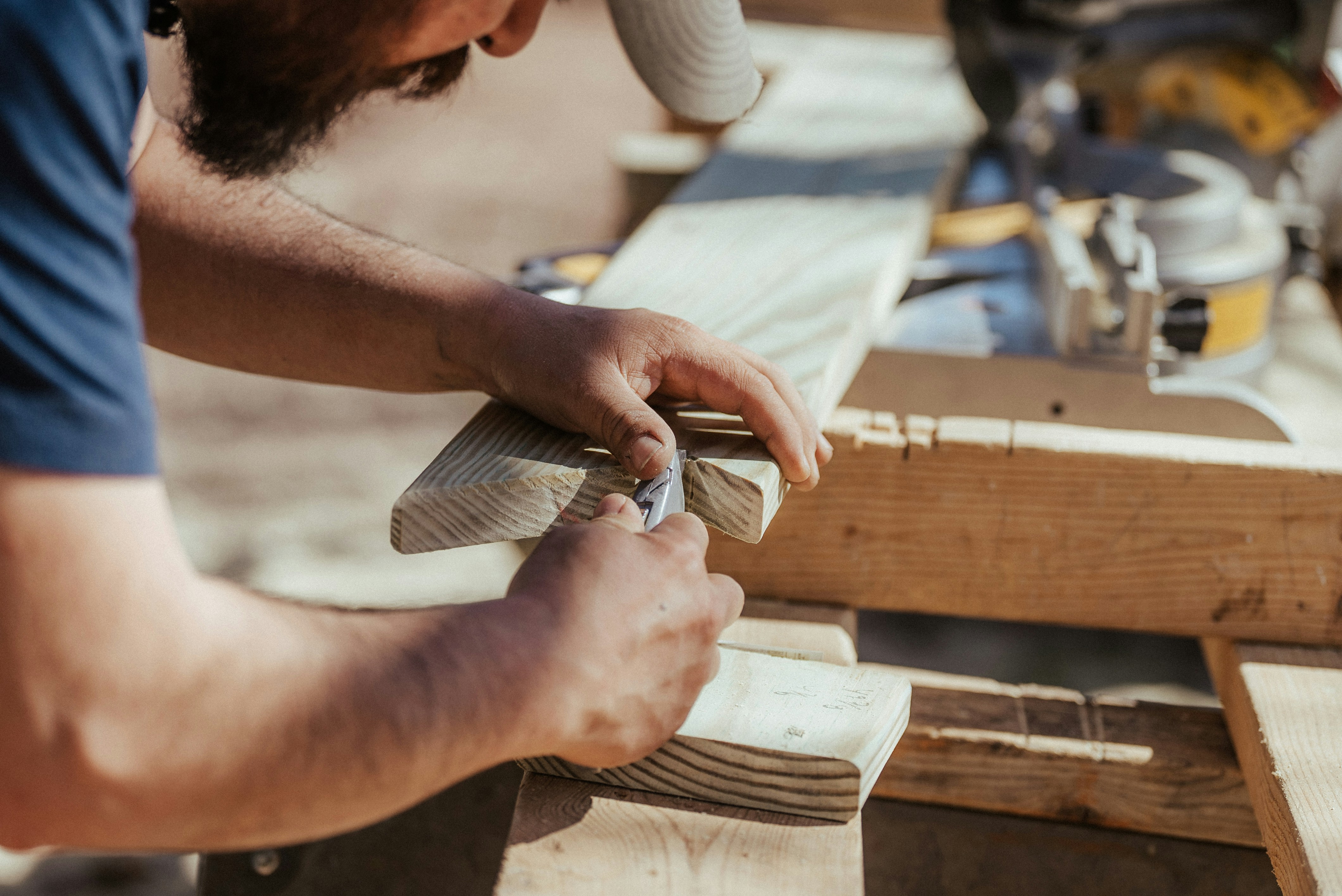 Man doing wood working on two by four