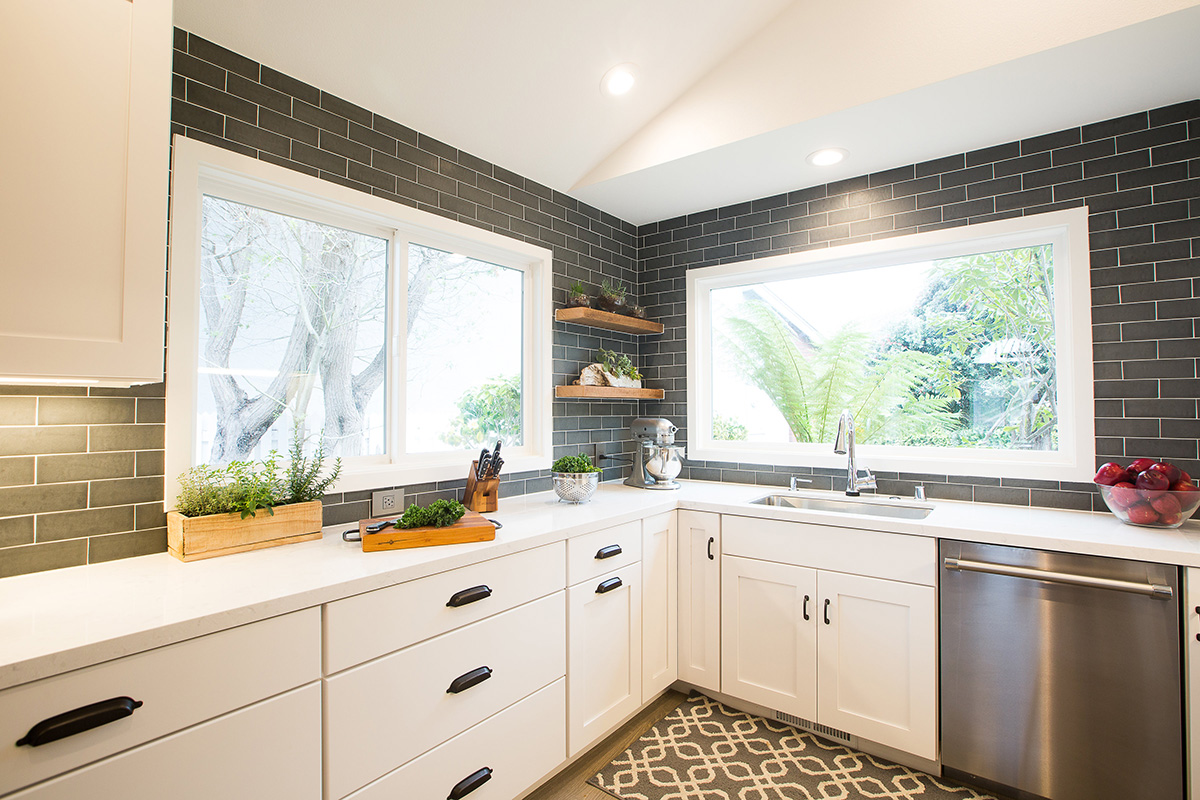 modern-industrial-kitchen-counter-white-cabinets-sink-windows